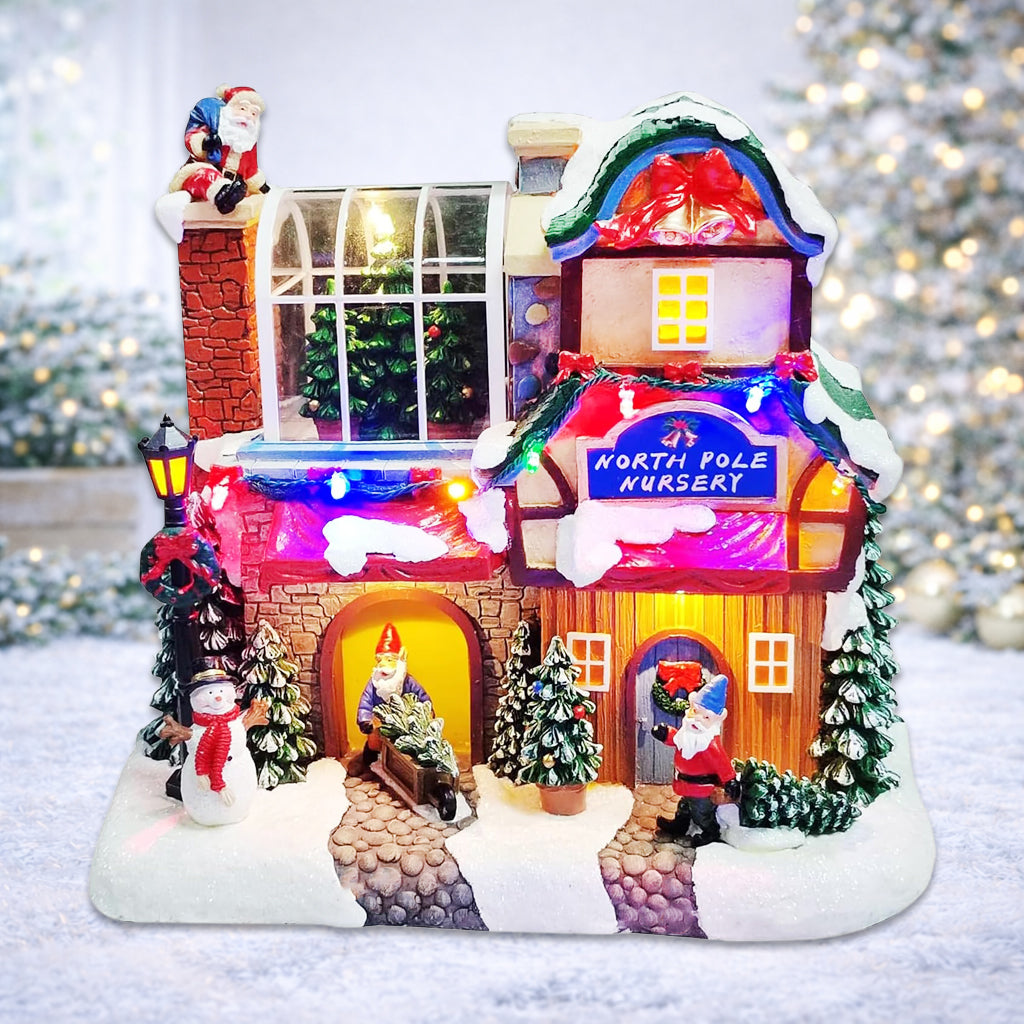 Musical North Pole Nursery Christmas Village 9.3” LED Polyresin Lighted Holiday House with Santa Gnomes Snow Scene